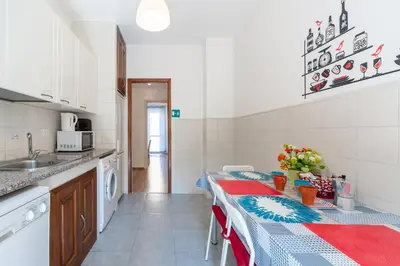 a kitchen with a table and a sink and a counter at Vatican Stemar Apartment in Rome