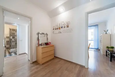 a white room with a dresser and a mirror at Vatican Stemar Apartment in Rome