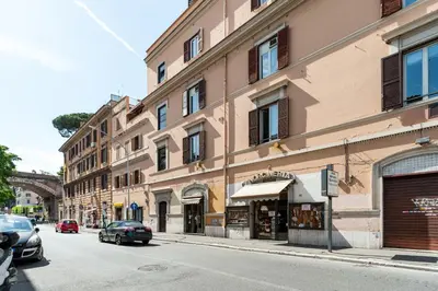 a building on a street with cars parked on the street at Vatican Stemar Apartment in Rome