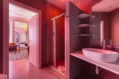 a bathroom with a white sink and a shower at Maison Degli Artisti Suites in Rome