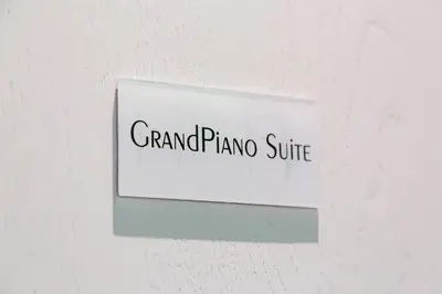a sign that reads grand piano suite on a wall at Maison Degli Artisti Suites in Rome
