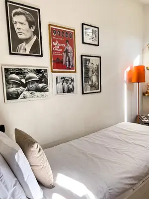 a bedroom with a bed with pictures on the wall at MGPgroup Have a Nice Day in Rome