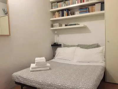 a bed with white towels on it in a room at Small Navona Studio in Rome