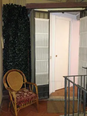 a chair sitting in a room with a wall at Small Navona Studio in Rome