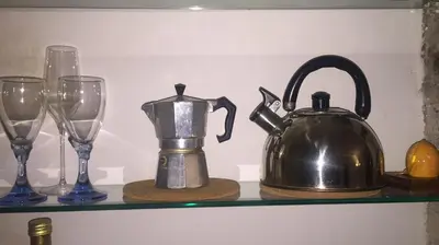 a shelf with a tea kettle and glasses on it at Small Navona Studio in Rome