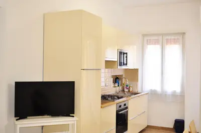a kitchen with a flat screen tv in a kitchen at Butterfly Suite Rome in Rome