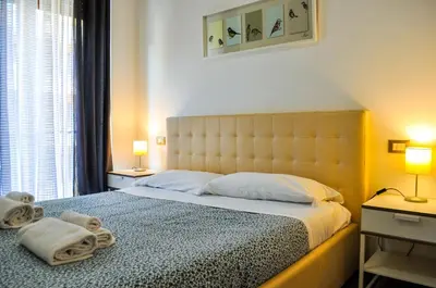 a bedroom with a large bed with towels on it at Butterfly Suite Rome in Rome
