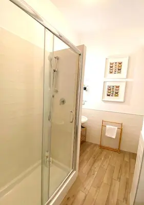 a shower with a glass door in a bathroom at Butterfly Suite Rome in Rome