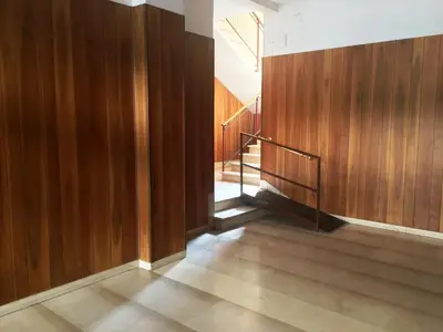a hallway with wood paneling and stairs in a building at Butterfly Suite Rome in Rome