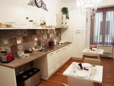 a kitchen with a sink and a counter top at More Cola di Rienzo B&B in Rome