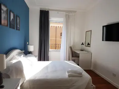 a bedroom with a white bed and a window at More Cola di Rienzo B&B in Rome