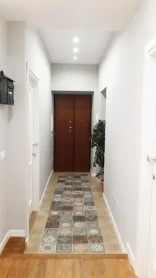 a hallway with a door and a tile floor at More Cola di Rienzo B&B in Rome