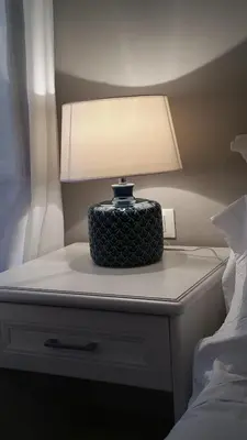 a lamp on a night stand next to a bed at More Cola di Rienzo B&B in Rome