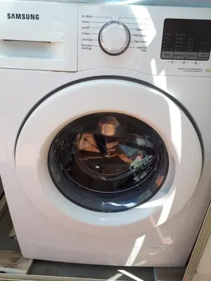 a white washing machine with its door open at Attico Pavia vicino Policlinico in Rome
