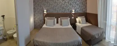 a bedroom with two beds with pillows at At your Place in Rome