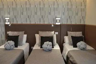 two beds with pillows on them in a room at At your Place in Rome