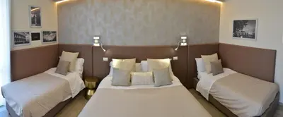 a room with two beds with white sheets and pillows at At your Place in Rome