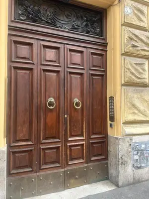 a large wooden door on the side of a building at At your Place in Rome