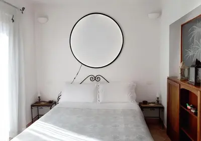 a bedroom with a large mirror above a bed at Panoramic Apartment in Rome
