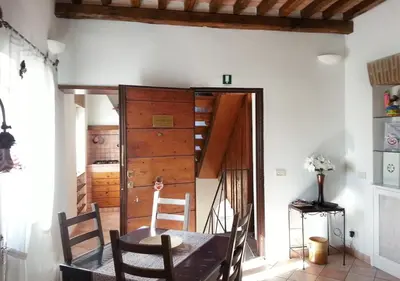 a dining room with a table and a wooden door at Panoramic Apartment in Rome