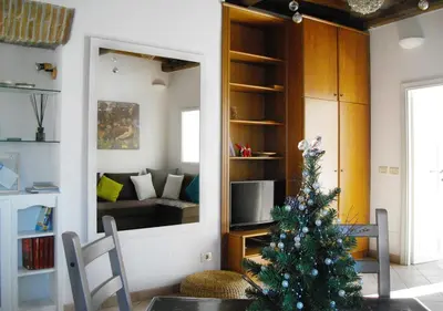 a christmas tree on a table in a living room at Panoramic Apartment in Rome