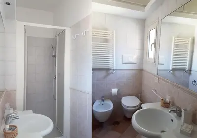 a bathroom with two sinks and a toilet and a shower at Panoramic Apartment in Rome