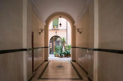 an empty hallway with an archway in a building at Simon's place in Rome
