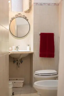 a bathroom with a toilet and a sink and a mirror at Simon's place in Rome