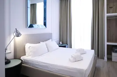 a bedroom with a white bed with towels on it at Aureliana Luxury Apartments in Rome