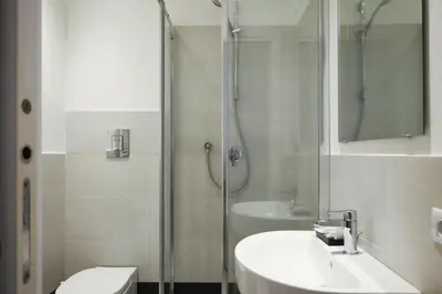 a bathroom with a shower and a sink and a toilet at Aureliana Luxury Apartments in Rome