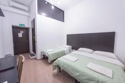 a room with two beds and a tv in it at Lemei House in Rome