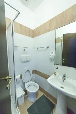 a bathroom with a toilet and a sink at Lemei House in Rome