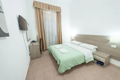 a hotel room with a bed and a television at Lemei House in Rome