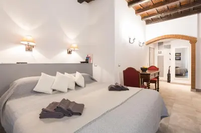 a bedroom with a large bed with towels on it at Roman Forum Suite in Rome