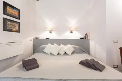 a bedroom with a bed with two towels on it at Roman Forum Suite in Rome