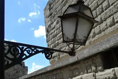 a street light on the side of a brick wall at Roman Forum Suite in Rome