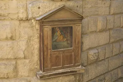 a painting of a woman on a brick wall at Roman Forum Suite in Rome