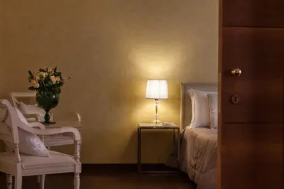 a bedroom with a bed and a table with a vase of flowers at Prestigious Apartment Piazza Navona in Rome