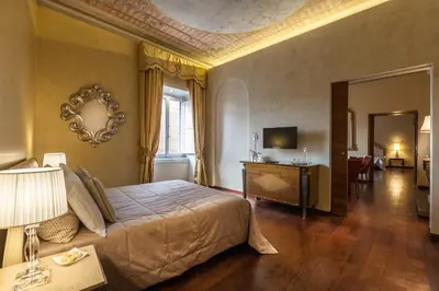 a bedroom with a large bed and a living room at Prestigious Apartment Piazza Navona in Rome