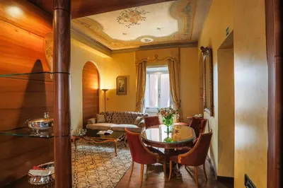 a living room with a table and a couch at Prestigious Apartment Piazza Navona in Rome
