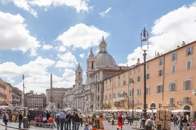 a crowd of people walking around a street with buildings at Prestigious Apartment Piazza Navona in Rome