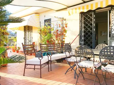 a group of chairs and tables on a patio at Roma Suite Balduina in Rome