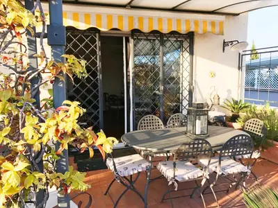 a patio table and chairs on a porch at Roma Suite Balduina in Rome