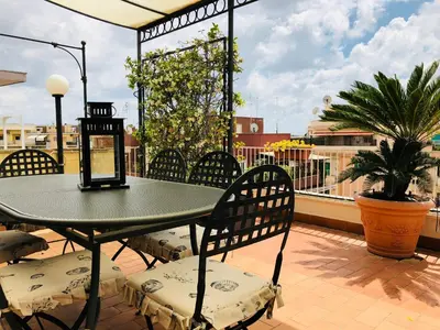 a table and chairs sitting on a balcony at Roma Suite Balduina in Rome