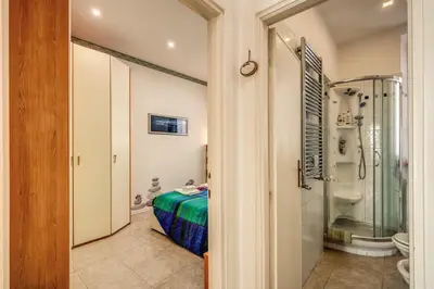 a bathroom with a bed and a shower and a toilet at GreenSugarHome in Rome