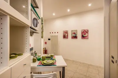 a kitchen with a table and chairs in a room at GreenSugarHome in Rome