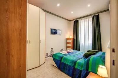 a small bedroom with a bed and a window at GreenSugarHome in Rome