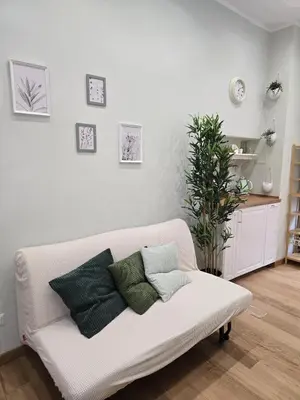 a white couch with pillows on it in a living room at Rome Candia Holiday House in Rome