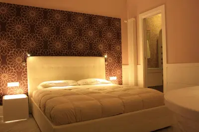 a bedroom with a large bed and a bathroom at Tuttelestrade - The apartment in Rome