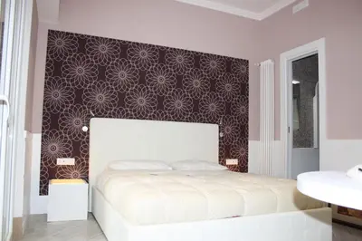 a bedroom with a bed and a black and white wall at Tuttelestrade - The apartment in Rome